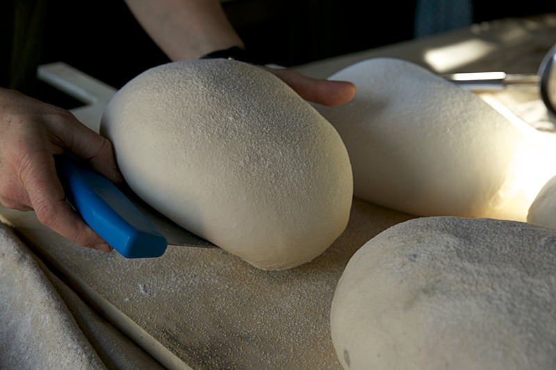 Place risen dough on peal for bread baked in the Fontana wood-fired oven
