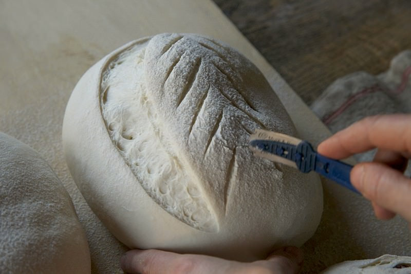 Score dough for bread baked in the Fontana wood-burning oven