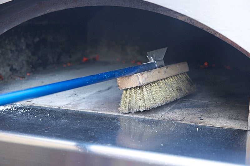 Sweep oven floor Score dough for bread baked in the Fontana wood-fired oven