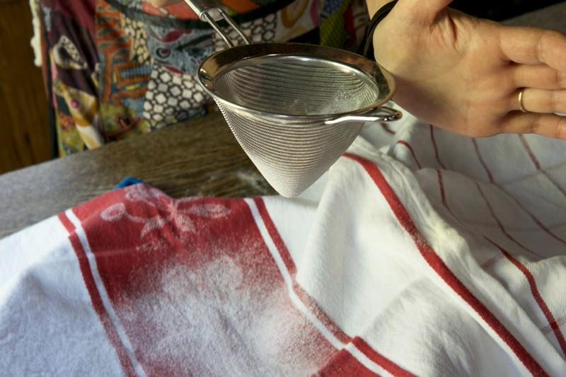 Sprinkle flour in covered baskets for bread dough baked in the Fontana wood-burning oven