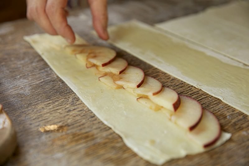 Sliced apples on puff pastry in Fontana wood-fired oven