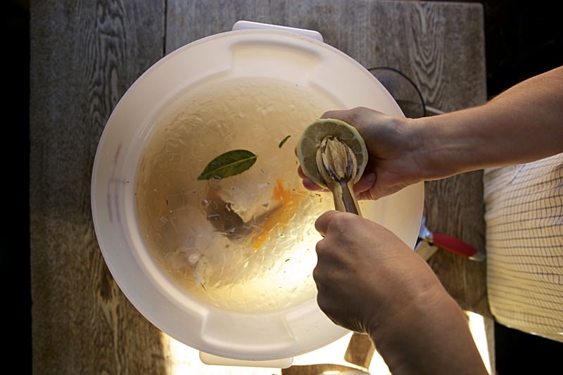 Pouring brine on turkey to be baked in Fontana brick oven 