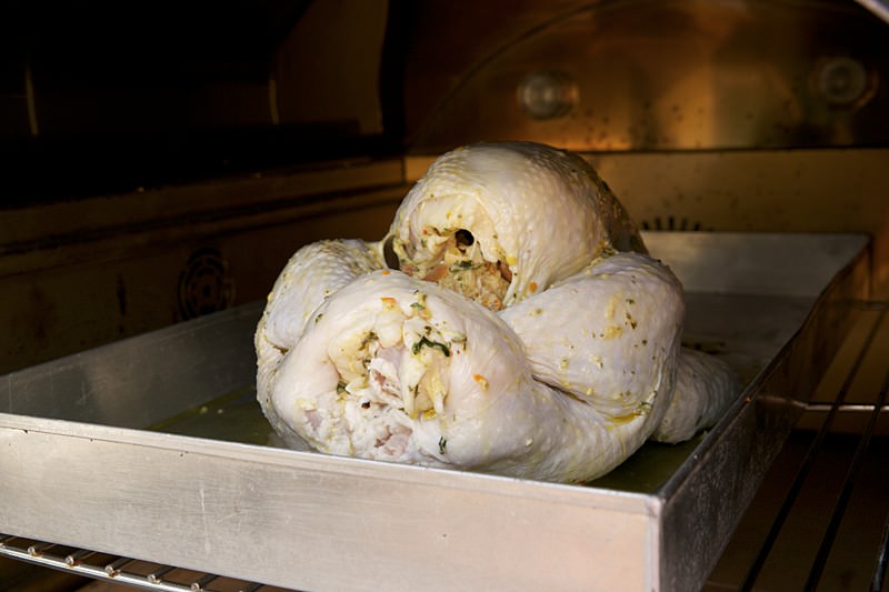 Placing turkey in the Fontana brick oven 