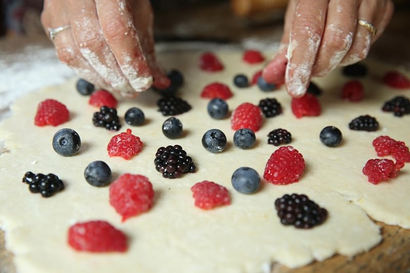 Once the dough is rolled out, place the fruit evenly over the entire surface.