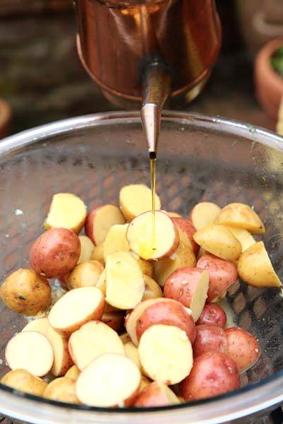 Drizzle oil on potatoes