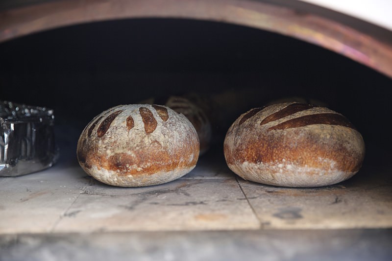 Bread being baked in the Fontana wood-fired oven