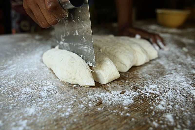 With a dough cutter, divide the dough into equal pieces