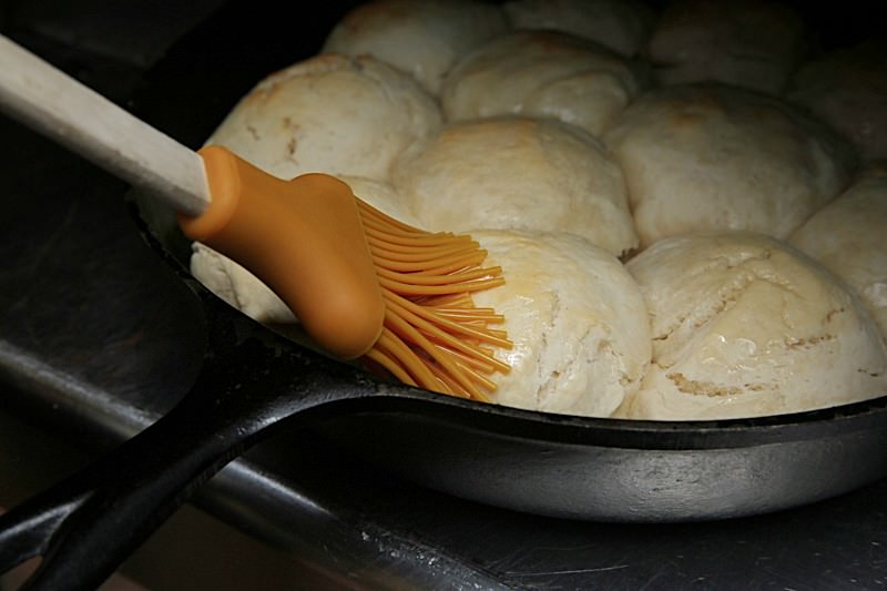 Spread melted butter over the top of the biscuits