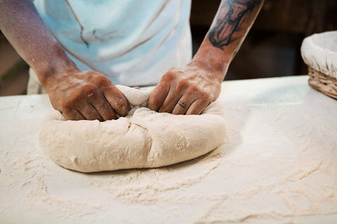 male hands making bread dough