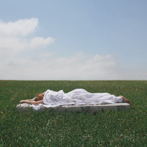 Women lying down in field