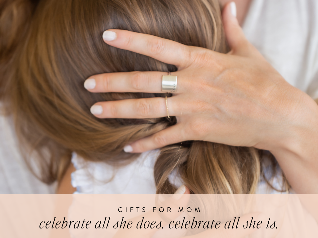 mother hugging daugher. featuring sterling silver wide ring and sterling silver petite stacking ring. text on image reads : gifts for mom celebrate all she does. celebrate all she is.