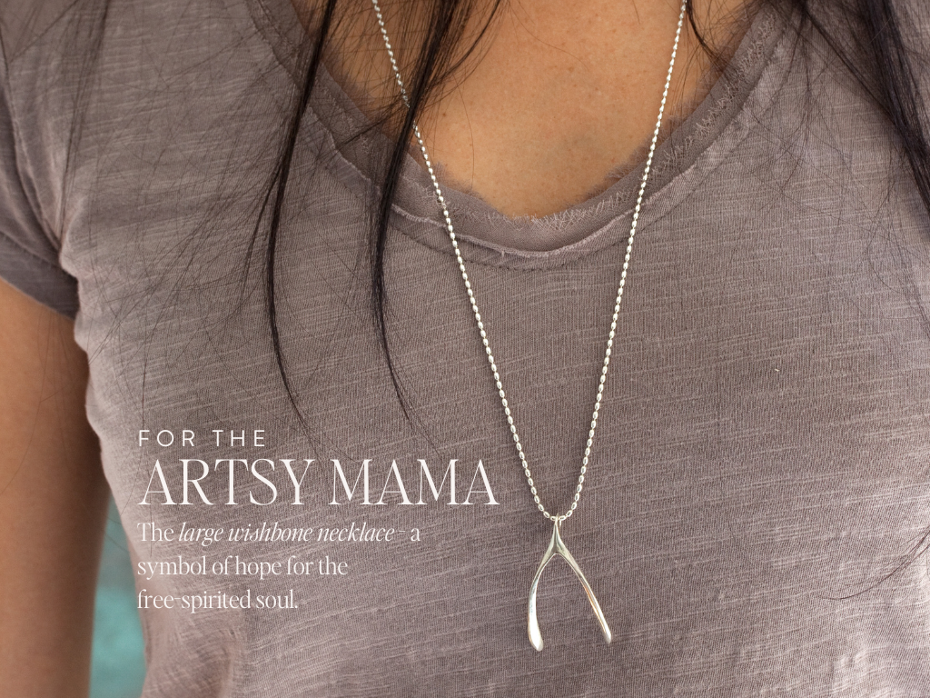 silver wishbone necklace on model with v-neck mauve tshirt. text on image reading : for the artsy mama, The large wishbone necklace - a symbol of hope for the  free-spir﻿ited soul.