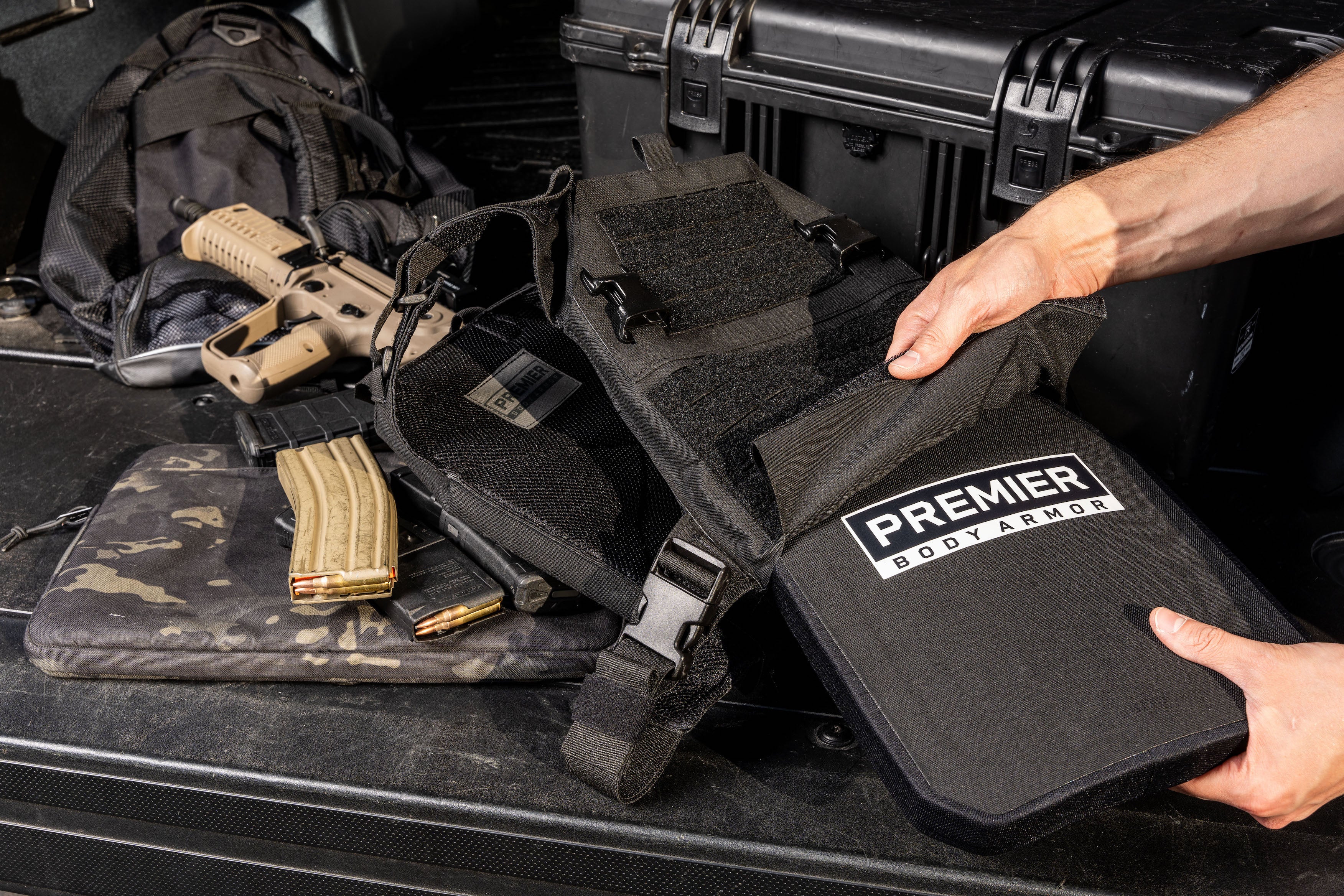 level 3 body armor with green tip protection being put into plate carrier with molle and buckles