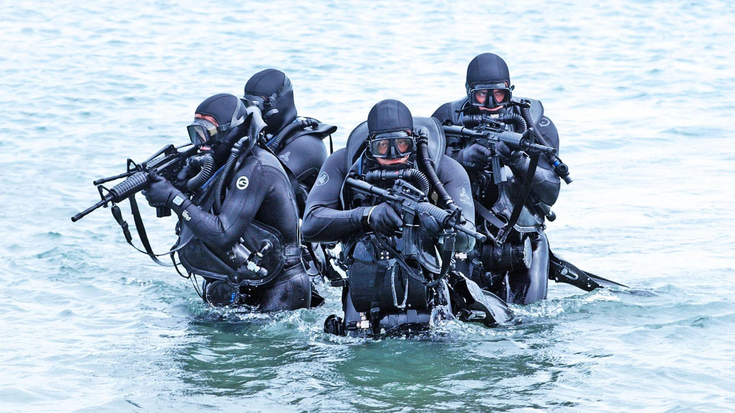 US Navy Seals submerging from water