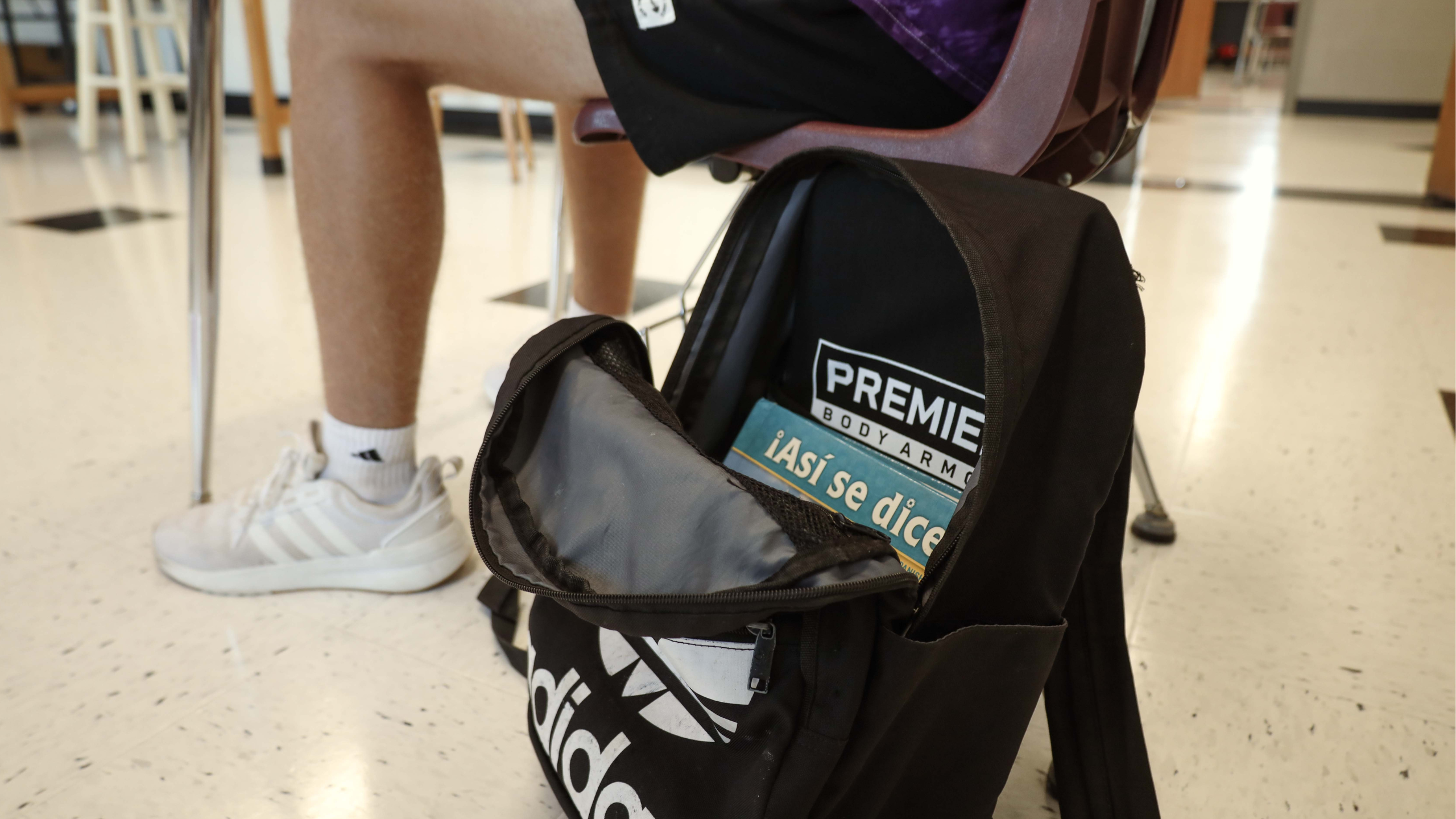 bulletproof backpack panel inside adidas bookbag in a classroom