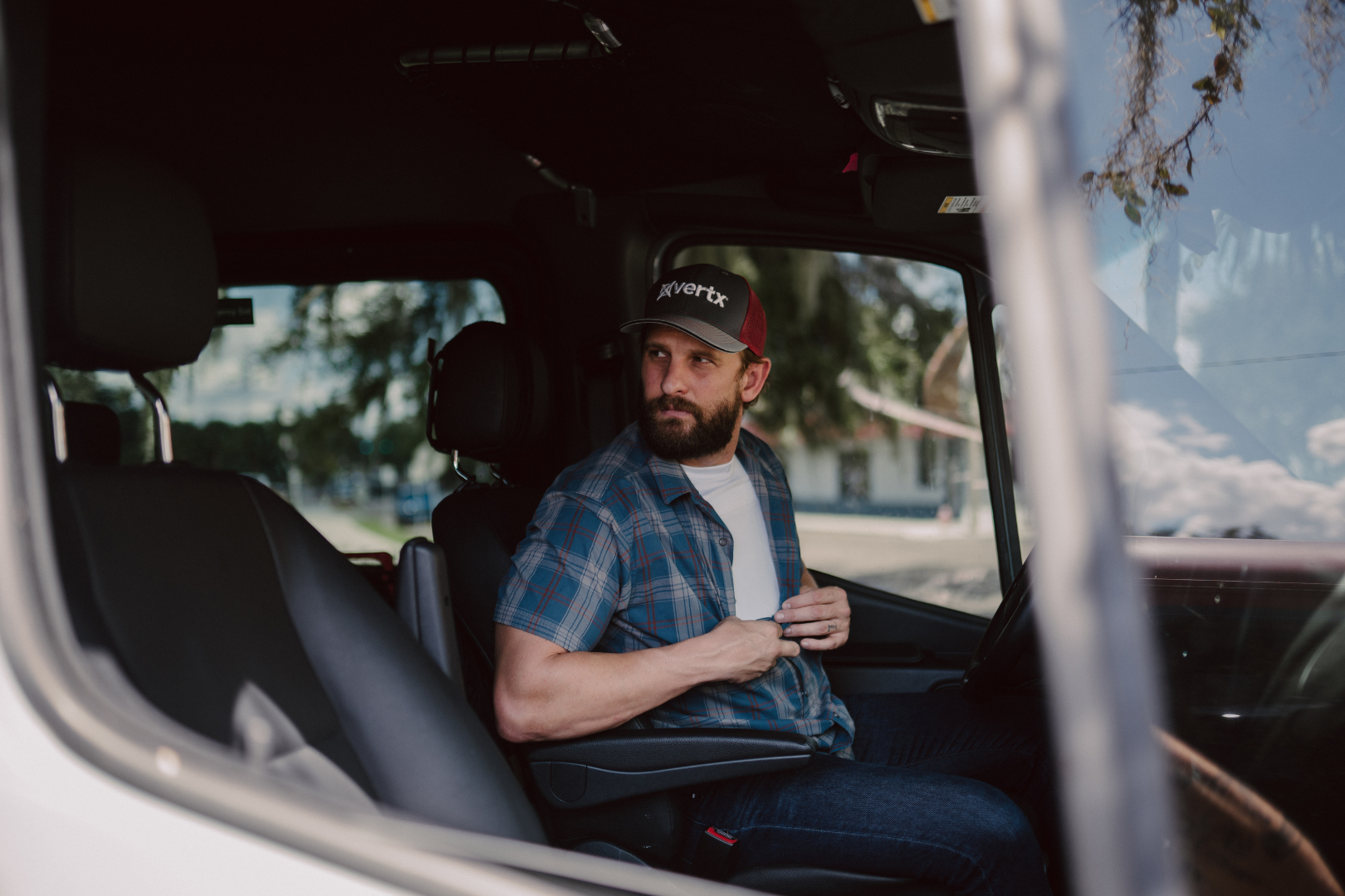 man wearing concealable body armor in truck