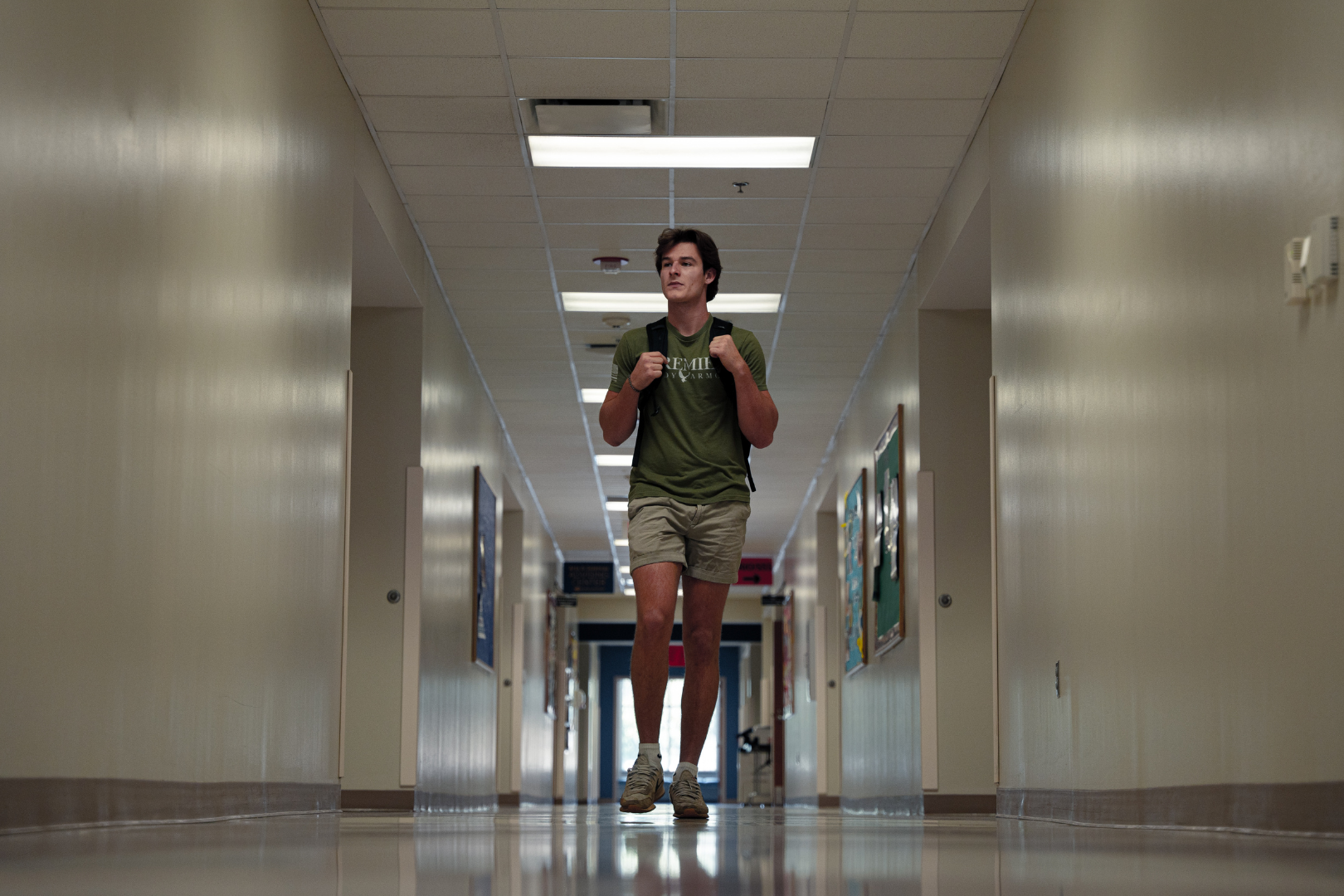 guy walking in school hallway