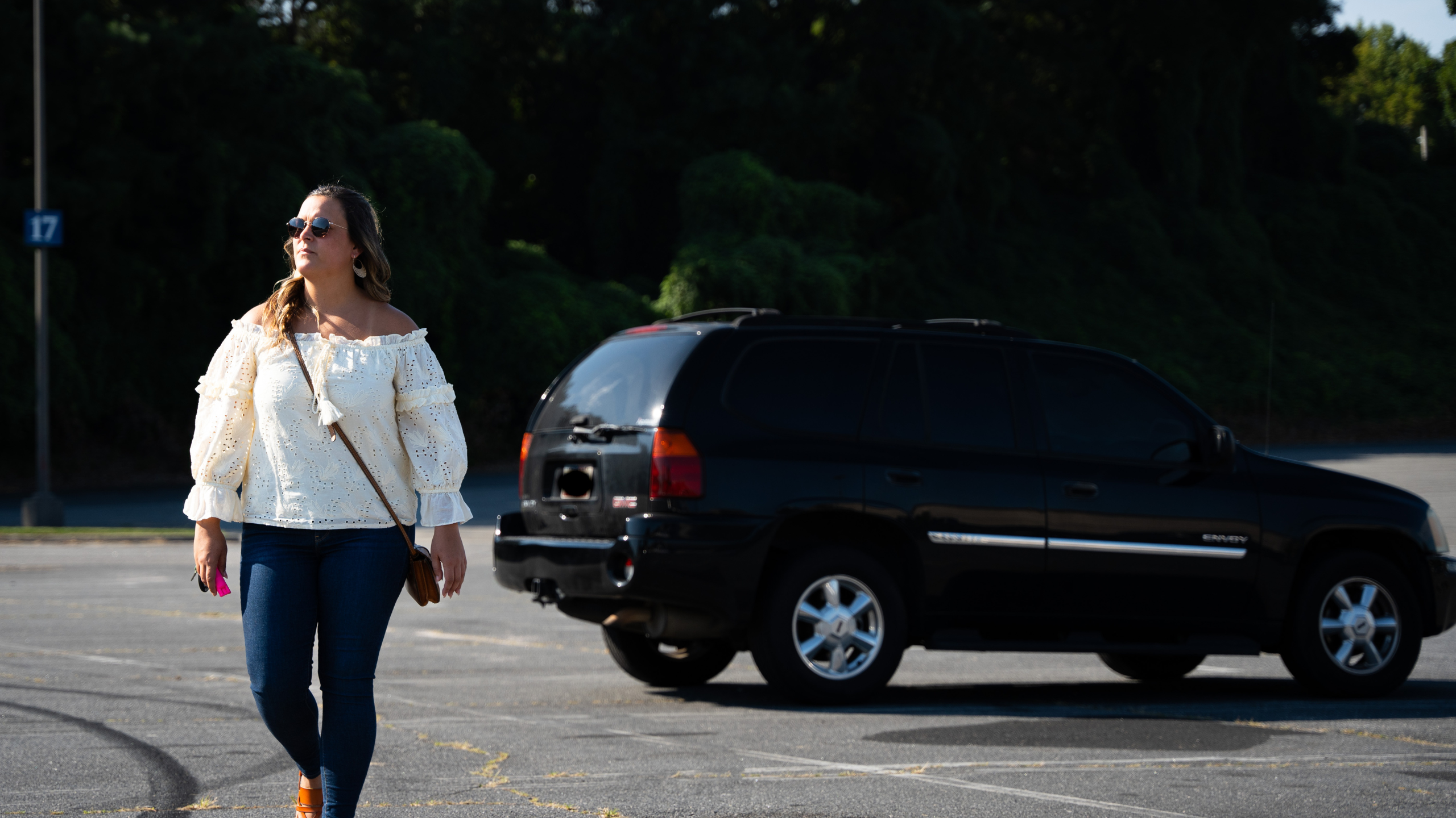 woman in parking lot walking away from car