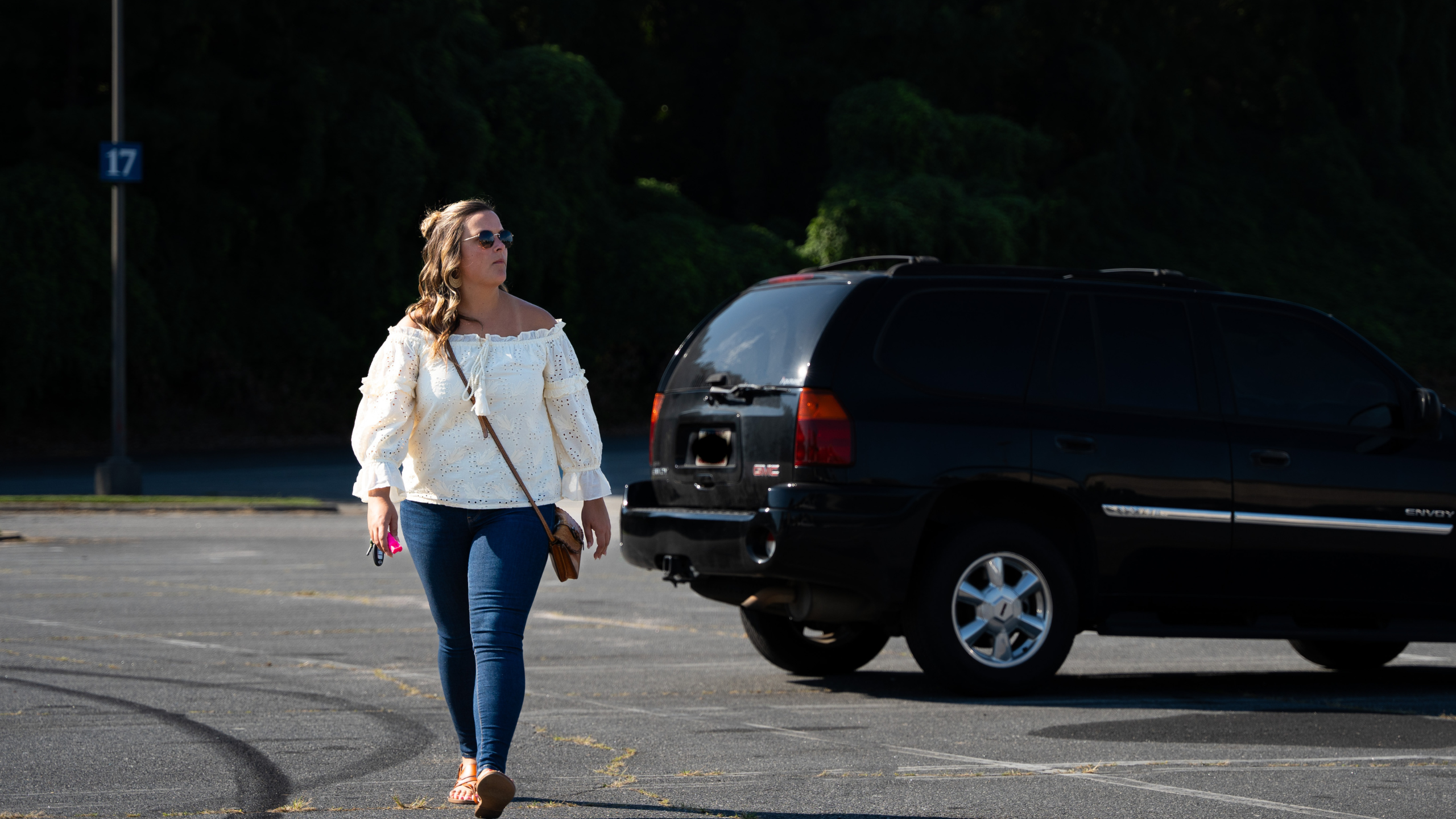 woman walking through parking lot alert