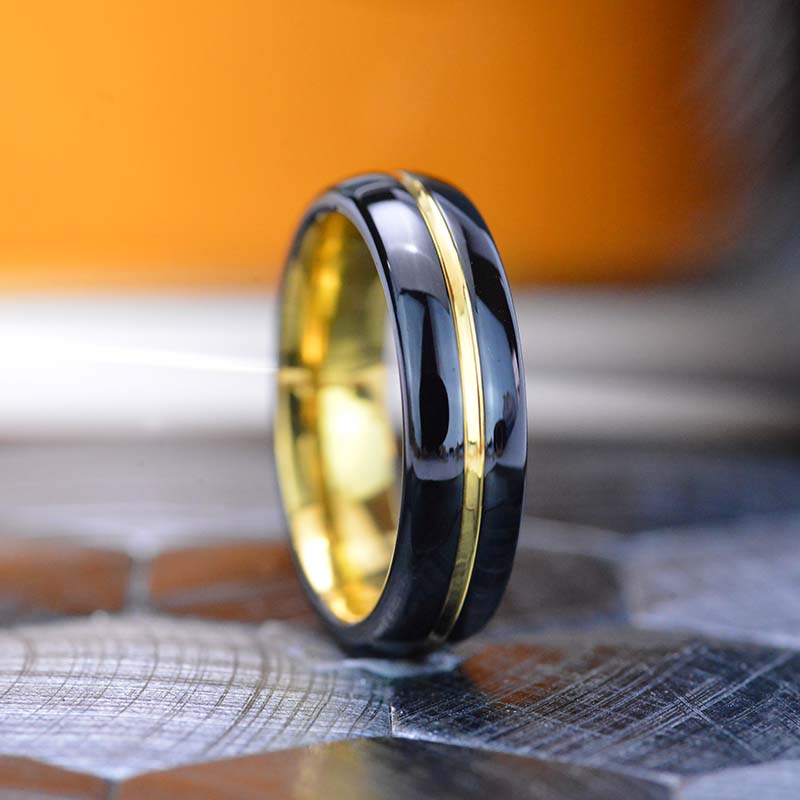 Mirror polished black tungsten band, with yellow gold color plated cen ...