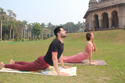 Two Yogis in Cobra Pose In India