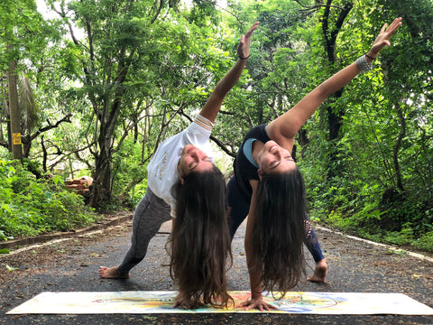 Two yoga girls in heart opening poses on an eco friendly yoga mat