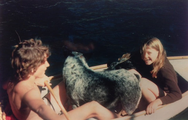 Two dogs, Rowena and her brother sitting in a boat.