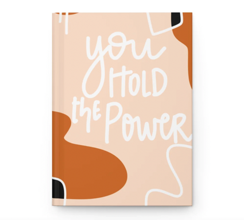 Hardcover Journal that says You Hold the Power on the front. Color scheme is nude, beige and black