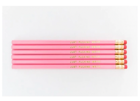 Light Pink wooden hexagon pencils that say Just Fucking Write in gold on one side. Imprinted. 
