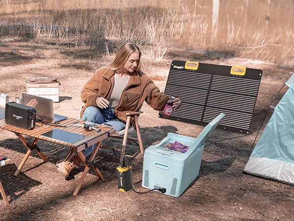 A Young Lady Camping With BougeRV’s Colored Mini Fridge and the BougeRV’s Colored Fridge Green Mini Fridge Can Run on BougeRV Battery for Mini Fridge