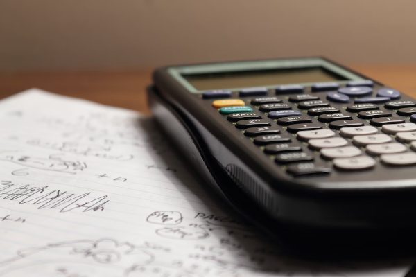A calculator and draft on the desk 