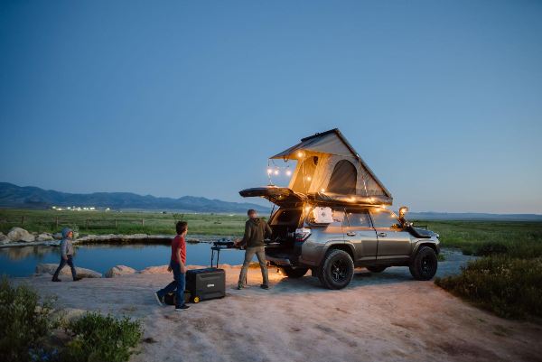 A family Overlanding near a pool with BougeRV’s portable camping fridge