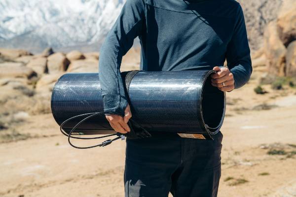 A man carrying a BougeRV flexible CIGS solar panel 