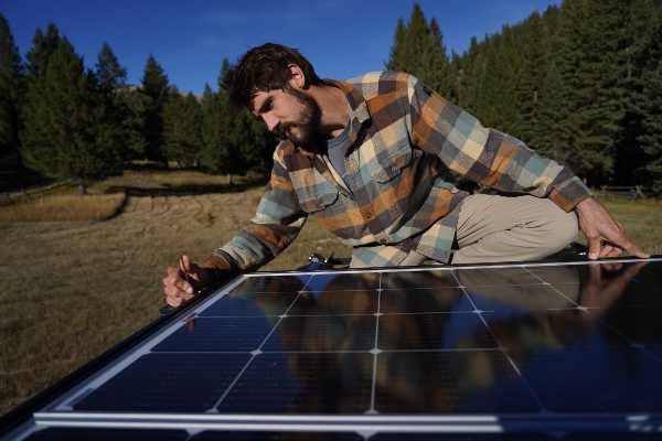 A man checking an affordable and quality BougeRV solar panel