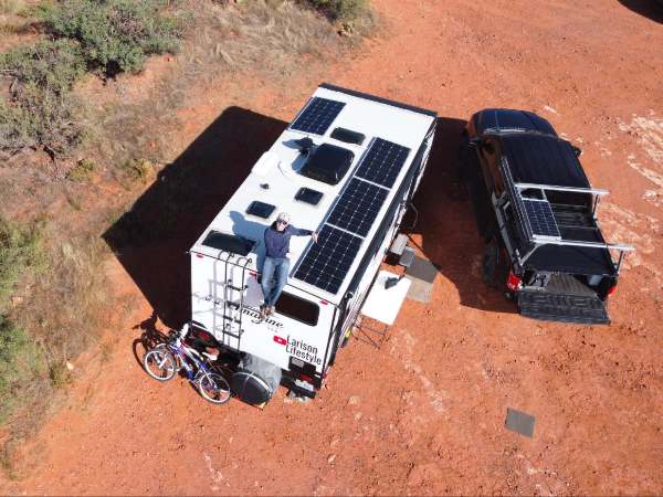 A man sitting on an RV where BougeRV’s solar panels installed