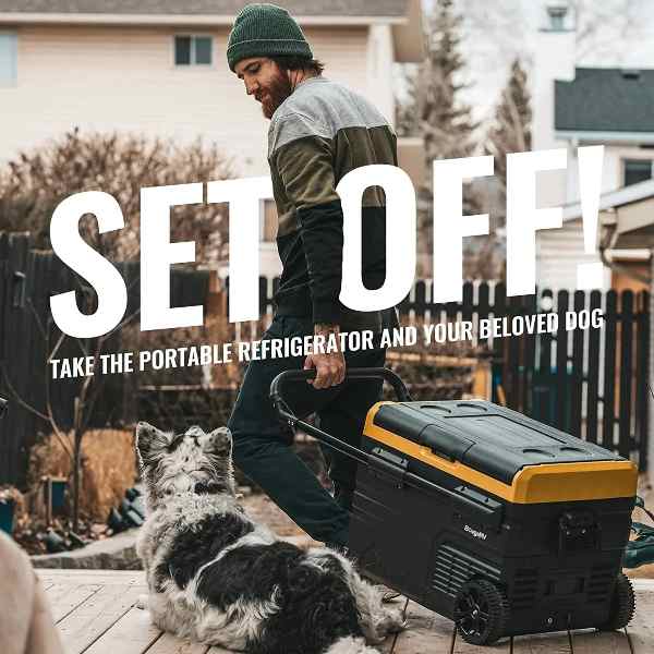 A man, with his dog by his side, prepares to head out, equipped with BougeRV's portable mini fridge on wheels