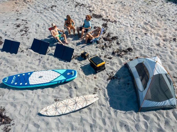 Friends enjoying BougeRV 100W solar panels on the beach