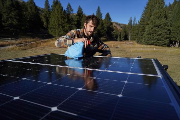 Inspecting and gently brushing rigid solar panels using a soft cloth