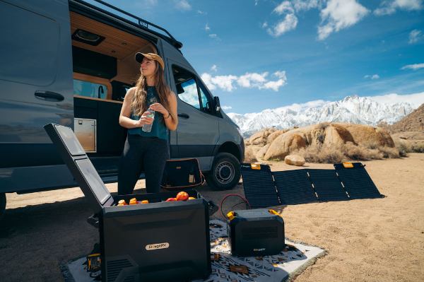 a woman camping using BougeRV’s 12V portable fridge and solar generator