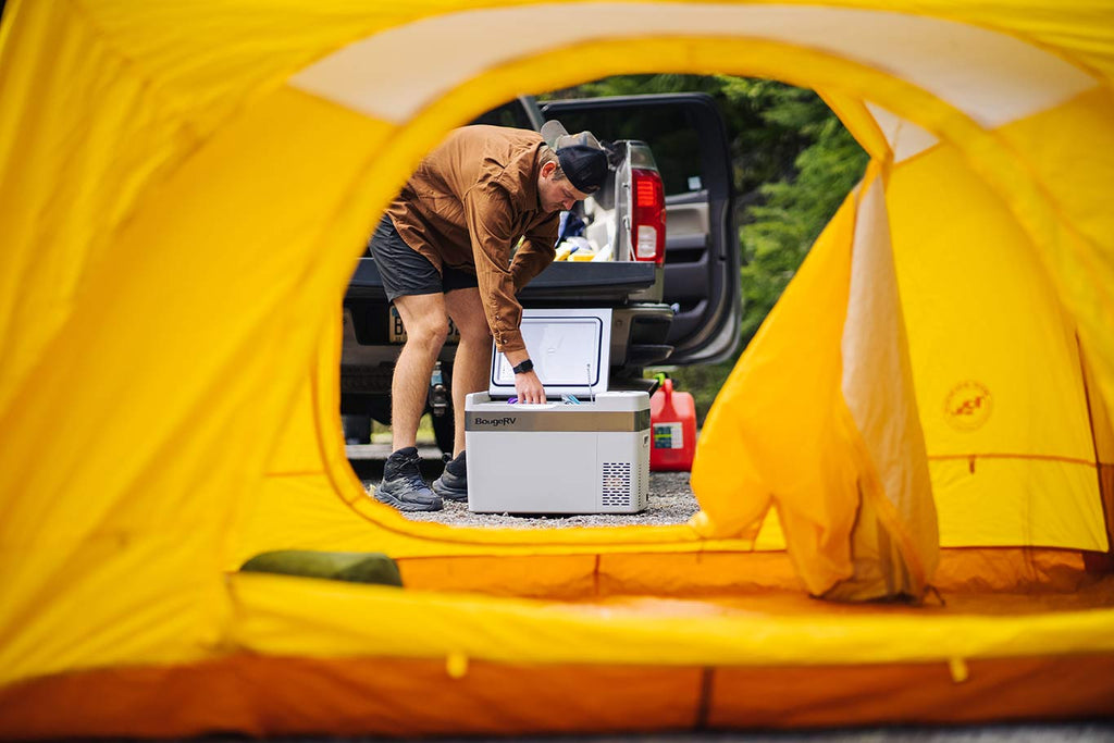 A camper is using a 12V refrigerator
