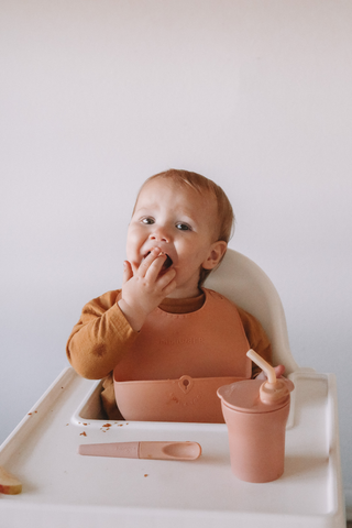 Toddler at meal time practicing BLW using Miniware Sili Mini Go