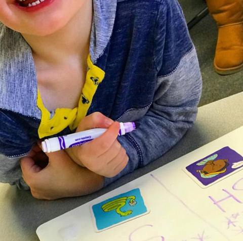 child using Bjorem speech sound cues in speech therapy to cue for listening to the difference between the sh and s sounds