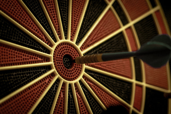 A dart in the bulls eye of a dartboard