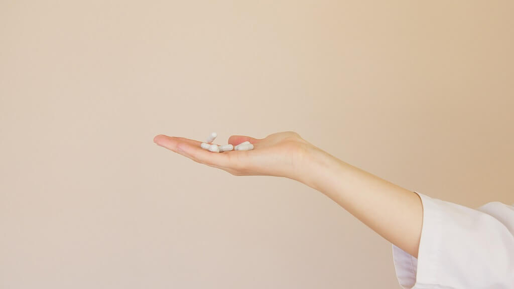 Hand holding probiotic capsules