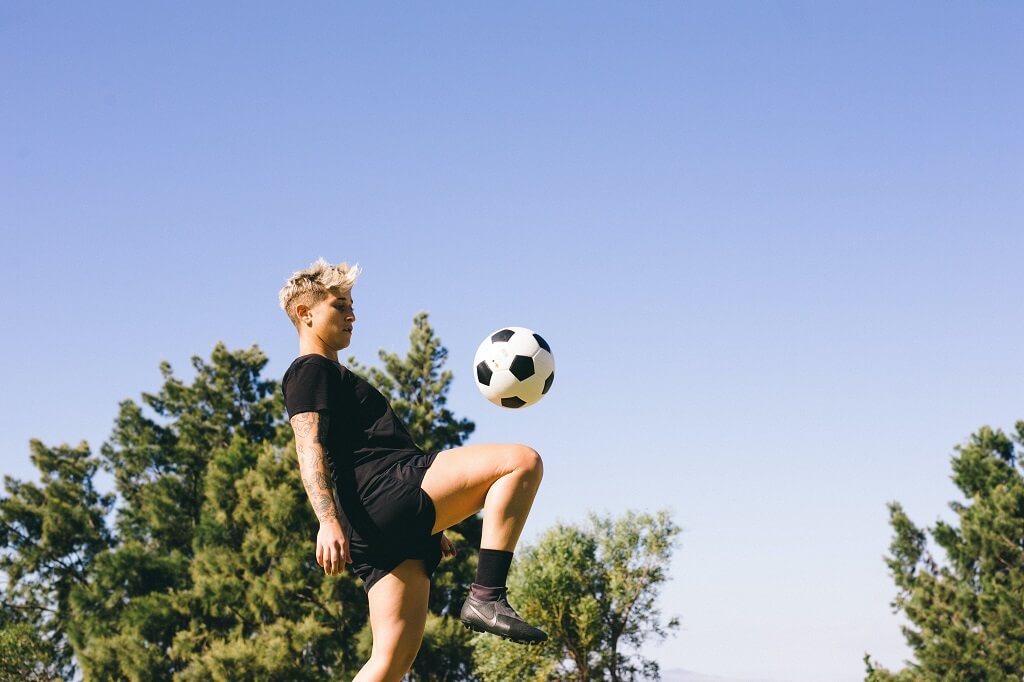 Person playing soccer outside