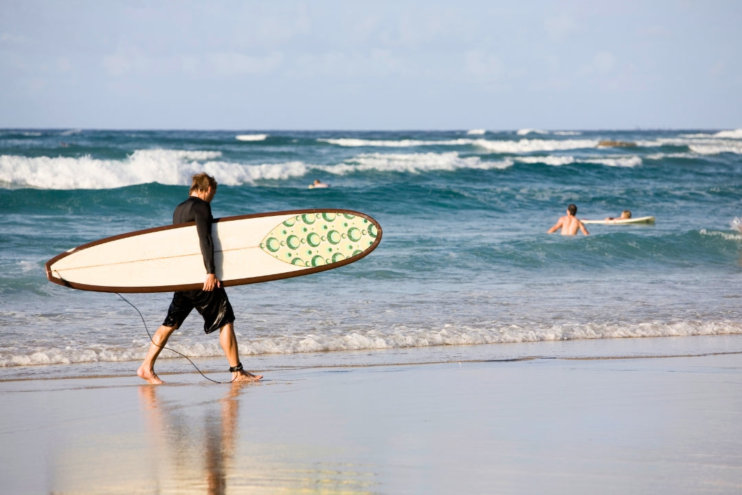 waves and surfer holding longboard malibu surfrider beach