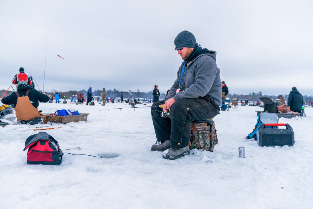 winter vacation ideas man ice fishing