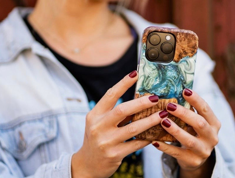 woman holding wood phone case