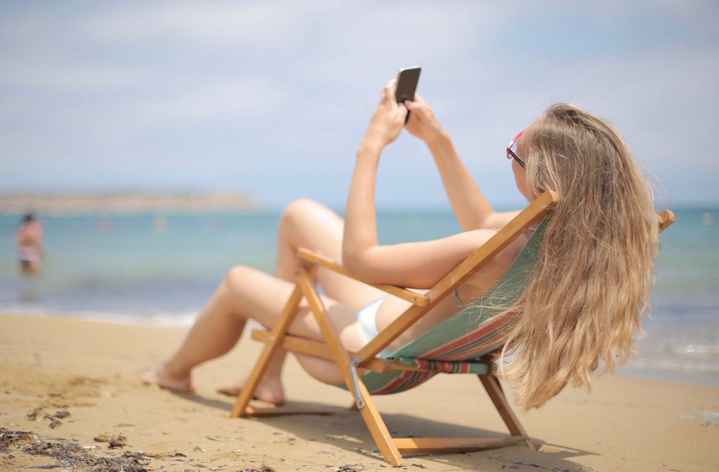 woman using smartphone on sunny day