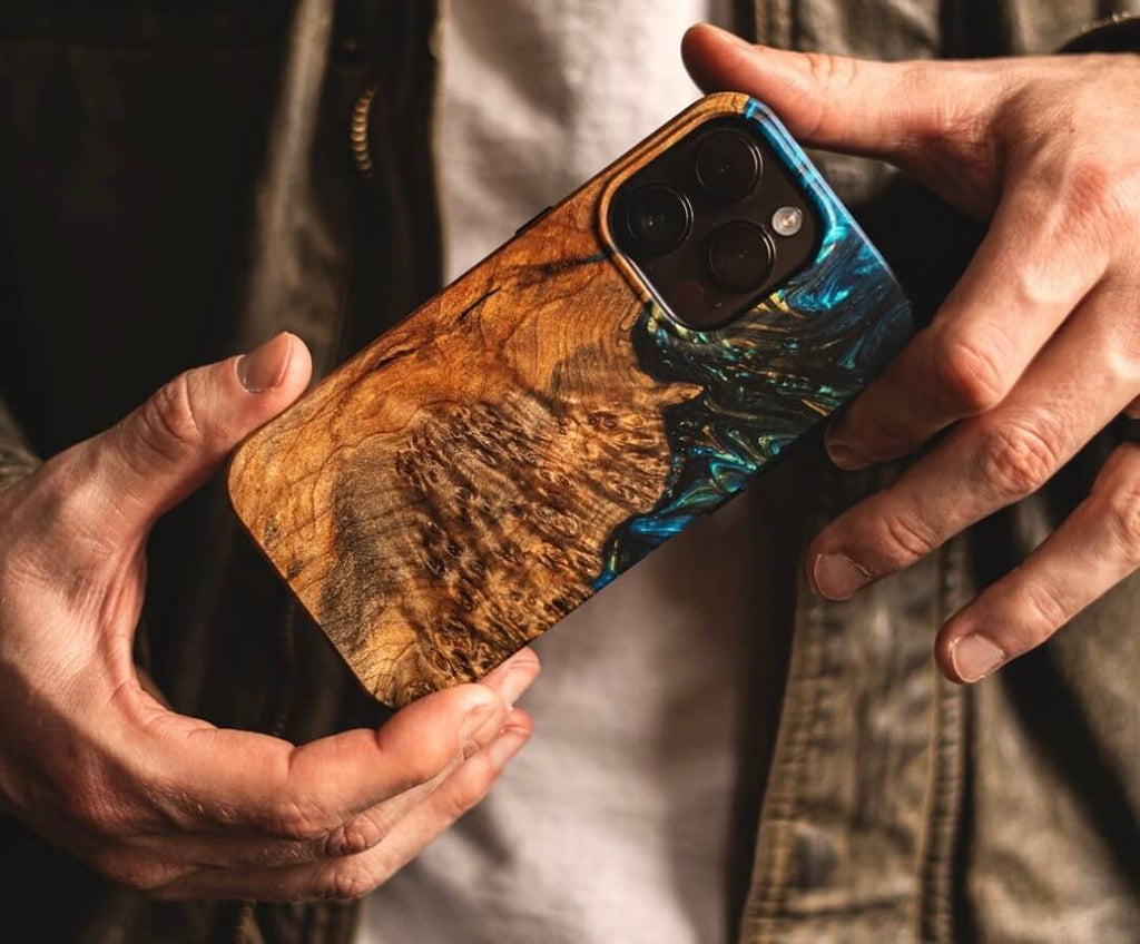 man holding hard wooden phone case